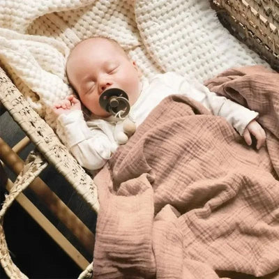Bébé recouvert couverture bébé unie couleur chocolat dans landau