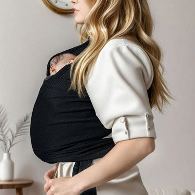 Maman se préparant sortir portant bébé dans echarpe de portage bebe noire ergonomique confortable