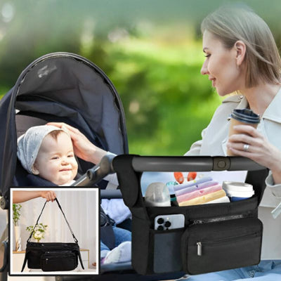 maman-regardant-son-bébé-dans-un-parc-à-côté-de-sa-poussette-sur-laquelle-est-accrochée-son-sac-à-langer-velcro-contenant-la-pochette-détachable-lingettes-biberon-de-lait-et-gobelet-hermétique-eau-couches
